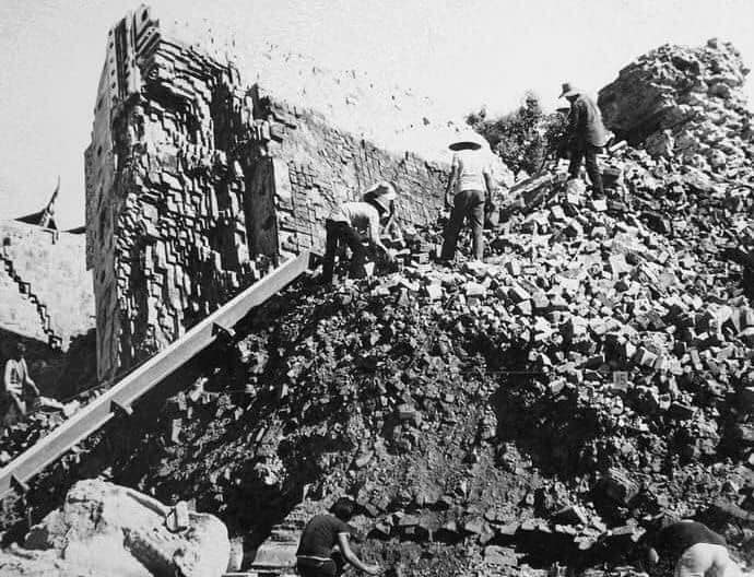 Villagers sifting through the remains of the temple